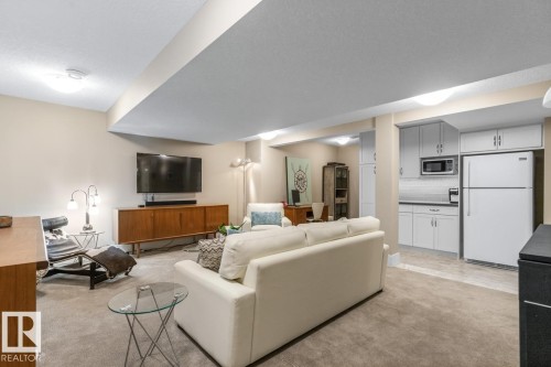 Spacious Basement Rec Room Custom Built by the Home Builder (Homes by Avi), Features a Bar Space, Full Sized Refrigerator, and Wine Room - 7432 Colonel Mewburn Road, Edmonton, AB - Indoor Photo Showing Living Room
