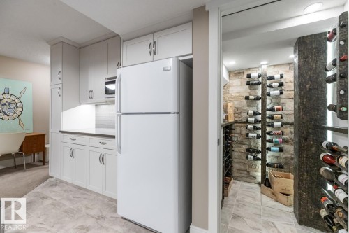 Spacious Basement Rec Room Custom Built by the Home Builder (Homes by Avi), Features a Bar Space, Full Sized Refrigerator, and Wine Room - 7432 Colonel Mewburn Road, Edmonton, AB - Indoor Photo Showing Kitchen