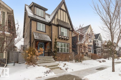 Exterior Front of House with Award Winning Low Maintenance Landscaping (Top 5 Front Yards in Bloom), Outdoor Speakers and Permanent Outdoor Trimlight Lighting - 7432 Colonel Mewburn Road, Edmonton, AB - Outdoor With Facade
