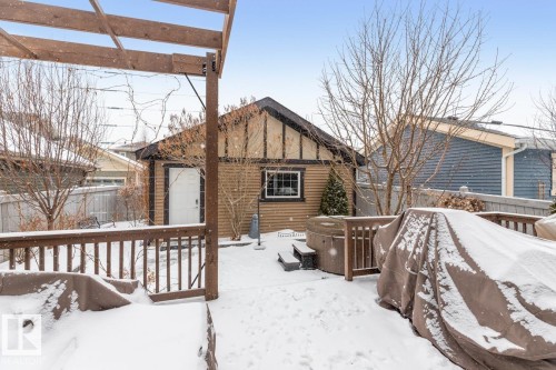 Exterior Back of House with Award Winning Low Maintenance Landscaping (Top 5 Front Yards in Bloom), Pergola, Gas BBQ Line, Outdoor Speakers and Permanent Outdoor Trimlight Lighting - 7432 Colonel Mewburn Road, Edmonton, AB - Outdoor