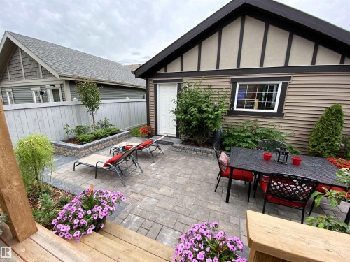 Exterior Back of House with Award Winning Low Maintenance Landscaping (Top 5 Front Yards in Bloom), Pergola, Gas BBQ Line, Outdoor Speakers and Permanent Outdoor Trimlight Lighting - 7432 Colonel Mewburn Road, Edmonton, AB - Outdoor With Deck Patio Veranda