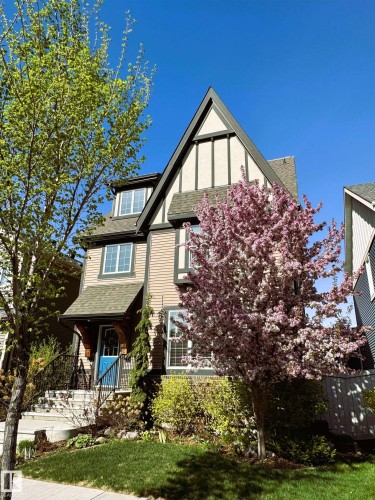 Summer Exterior Front of House with Award Winning Low Maintenance Landscaping (Top 5 Front Yards in Bloom), Outdoor Speakers and Permanent Outdoor Trimlight Lighting - 7432 Colonel Mewburn Road, Edmonton, AB - Outdoor