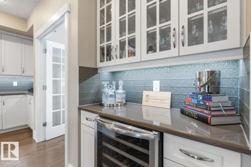 Bar Space located in Kitchen with Upgraded Glass Door Cabinets - 7432 Colonel Mewburn Road, Edmonton, AB - Indoor Photo Showing Kitchen
