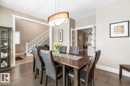 Formal Dining Room with Large East Facing Windows, Enough Room for 10 Guests, French Doors Leading the the Kitchen, and Maple Hardwood Flooring - 7432 Colonel Mewburn Road, Edmonton, AB - Indoor Photo Showing Dining Room