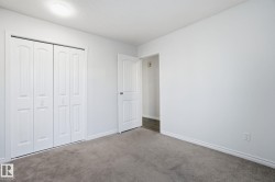 Unfurnished bedroom with carpet, a textured ceiling, and a closet - 