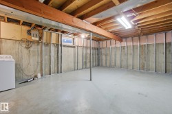 Unfinished below grade area with washer / clothes dryer - 