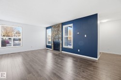 Unfurnished living room with a fireplace and wood finished floors - 