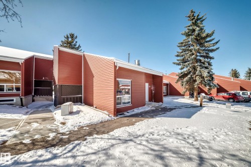 The property features red siding and white trim, with visible windows - 597 Millbourne Road E, Edmonton, AB - Outdoor