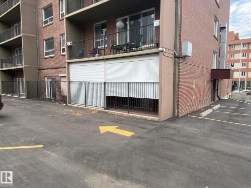 View of apartment building / complex with uncovered parking - 108 11025 Jasper Avenue, Edmonton, AB - Outdoor With Exterior