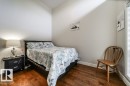 The room features polished hardwood floors and light-colored walls - 3 8050 Orchards Green, Edmonton, AB  - Indoor Photo Showing Bedroom 