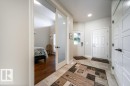 Entryway featuring tiled flooring, recessed lighting, and white paneled doors - 3 8050 Orchards Green, Edmonton, AB  - Indoor Photo Showing Other Room 