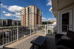 Private balcony with concrete flooring and white metal railings - 