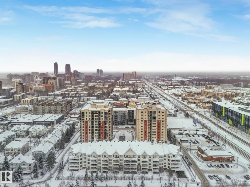 Aerial view of the neighborhood towards the west showcasing modern buildings, extensive roadways, and a distant city skyline - 515 10311 111 Street, Edmonton, AB - Outdoor With View