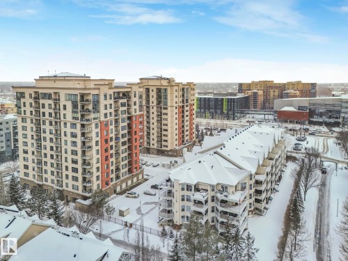 The property is part of a residential complex featuring multi-story buildings with balconies, with Grant MacEwen University less than one block to the north - 515 10311 111 Street, Edmonton, AB - Outdoor With View