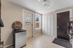 Back deck & garage entry featuring a textured ceiling and rail lighting - 