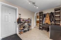 Spacious mudroom featuring arched walkways - 