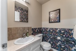 Half bath featuring vanity and wainscoting - 