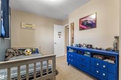 Bedroom with light carpet and a textured ceiling - 