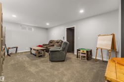 Living area with carpet floors and recessed lighting - 