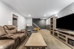 Carpeted living area with recessed lighting - 