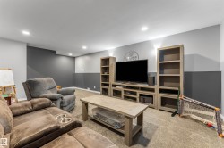 Carpeted living area featuring recessed lighting and baseboards - 