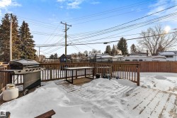 Snow covered deck with a residential view - 