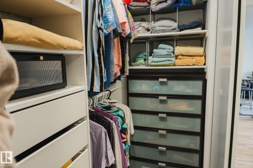 Custom closet system featuring shelving, hanging rods, and frosted drawer storage - 303 10432 76 Avenue, Edmonton, AB - Indoor Photo Showing Other Room