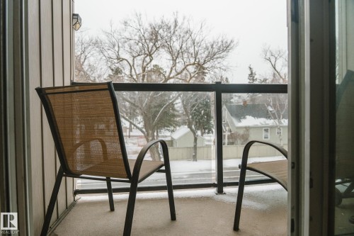 The property includes a private outdoor balcony with a glass railing, providing views of the neighborhood - 303 10432 76 Avenue, Edmonton, AB - Outdoor With Balcony