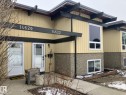 The property features a yellow exterior with dark trim accents and large windows - 14622 118 Street, Edmonton, AB  - Outdoor With Exterior 