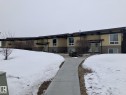 The property presents a pleasing exterior with a light-colored facade, dark trim, and stone accents - 14622 118 Street, Edmonton, AB  - Outdoor 