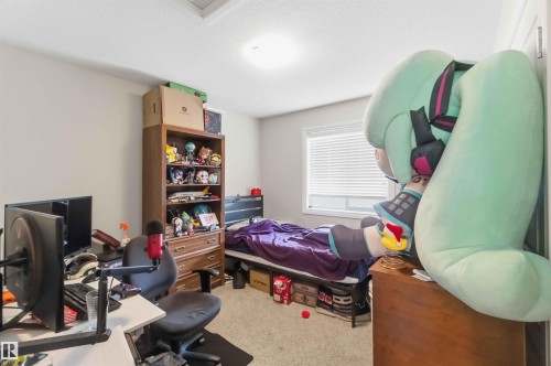 This room features light-colored walls and carpeted flooring, providing a neutral backdrop - 2037 69A Street, Edmonton, AB - Indoor Photo Showing Other Room