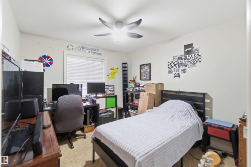 This room features light-colored walls, a window with blinds, and a ceiling fan - 2037 69A Street, Edmonton, AB - Indoor