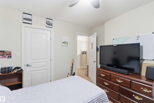 This room features a white ceiling with a ceiling fan, light-colored walls, and a white door with silver hardware - 2037 69A Street, Edmonton, AB - Indoor Photo Showing Bedroom