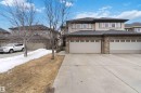 The property features a stone and siding exterior with a dark roof - 2037 69A Street, Edmonton, AB  - Outdoor With Facade 