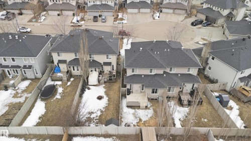 The property features a backyard with a wooden deck and a privacy fence - 2037 69A Street, Edmonton, AB - Outdoor