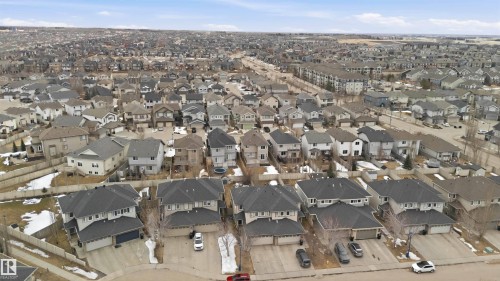 This aerial view showcases the extensive residential neighborhood, featuring numerous properties with dark-colored roofs and varied architectural styles - 2037 69A Street, Edmonton, AB - Outdoor With View