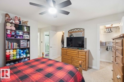 Bedroom featuring light-colored walls, a ceiling fan with integrated lighting, and carpeted flooring - 2037 69A Street, Edmonton, AB - Indoor Photo Showing Bedroom