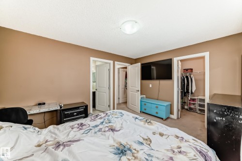 Bedroom featuring light brown walls and carpeted flooring - 23 445 Brintnell Boulevard Nw, Edmonton, AB - Indoor Photo Showing Bedroom