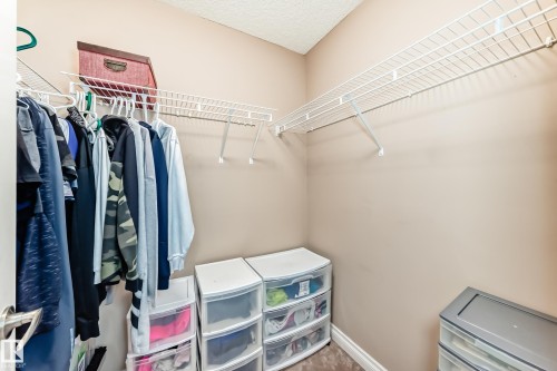 Walk-in closet featuring wire shelving and hanging rods - 23 445 Brintnell Boulevard Nw, Edmonton, AB - Indoor With Storage
