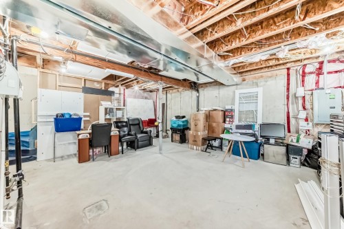 The property features an unfinished basement with a concrete floor, exposed ceiling joists, and visible ductwork - 23 445 Brintnell Boulevard Nw, Edmonton, AB - Indoor Photo Showing Basement
