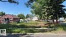 The property features a spacious lot with a gravel ground cover and partial fencing - 12072 95 Street, Edmonton, AB 