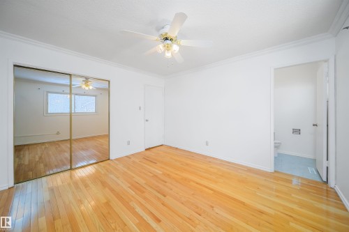 This room features hardwood flooring, white walls, and a ceiling fan - 6411 149 Avenue Nw, Edmonton, AB - Indoor Photo Showing Other Room