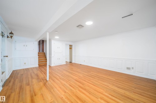 Finished room featuring light wood flooring, white walls with wainscoting, and recessed lighting - 6411 149 Avenue Nw, Edmonton, AB - Indoor Photo Showing Other Room