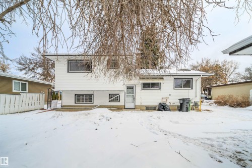 The property features white siding and dark trim around the windows, presenting a classic exterior - 6411 149 Avenue Nw, Edmonton, AB - Outdoor