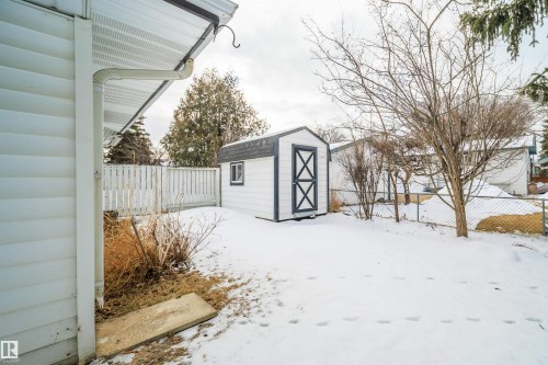 The property features a white exterior with white siding and a white gutter system - 6411 149 Avenue Nw, Edmonton, AB - Outdoor With Exterior