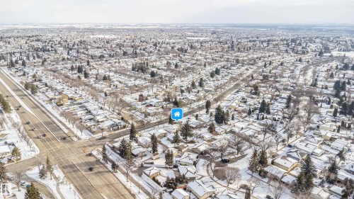 Aerial view showcasing a residential area with snow-covered rooftops and mature trees - 6411 149 Avenue Nw, Edmonton, AB - Outdoor With View