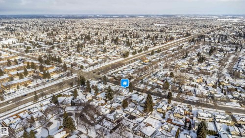 Aerial view of the neighborhood, showcasing residential properties with snow-covered rooftops and surrounding streets - 6411 149 Avenue Nw, Edmonton, AB - Outdoor With View