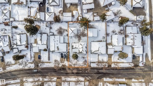 Aerial view of the property, showcasing its position within a neighborhood of homes with snow-covered roofs - 6411 149 Avenue Nw, Edmonton, AB - Outdoor With View