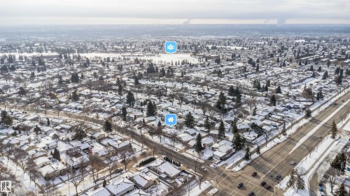Aerial view of the surrounding area featuring snow-covered rooftops, residential streets, and distant bodies of water - 6411 149 Avenue Nw, Edmonton, AB - Outdoor With View
