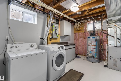 This home features upgraded electrical & plumbing and has a newer furnace, hot water tank and central air conditioning.  In addition to that, a sump pump and weeping tile have been recently installed . - 11924 141 Street, Edmonton, AB - Indoor Photo Showing Laundry Room